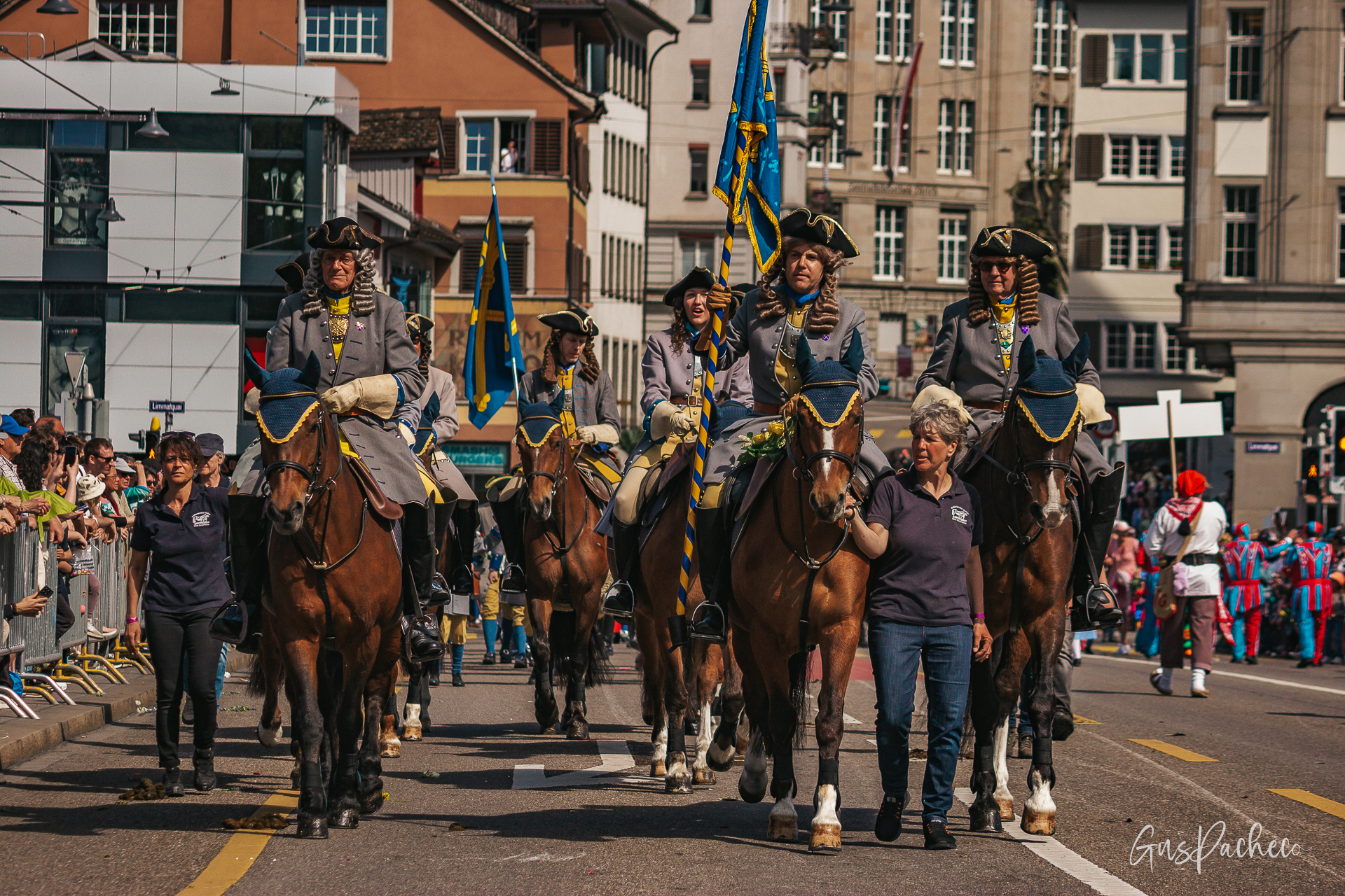 Sechseläuten — mounted guild members in wigs and 18th century costumes with blue and gold flags