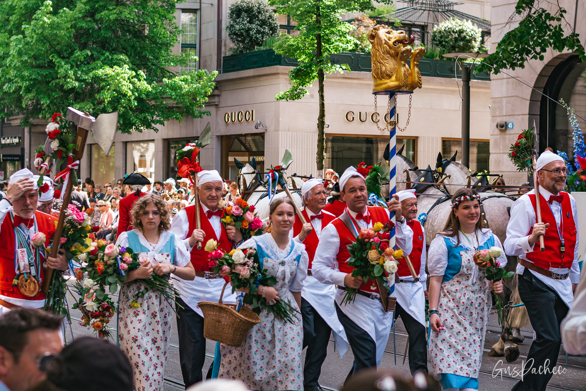 Sechseläuten drum corps in blue uniforms marching past Zunfthaus zur Zimmerleuten